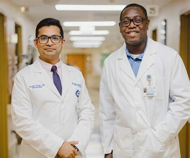 Two men in hospital hallway
