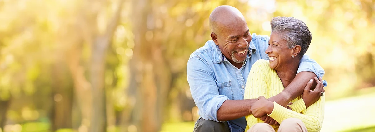 Man smiles at a woman as she listens to him.