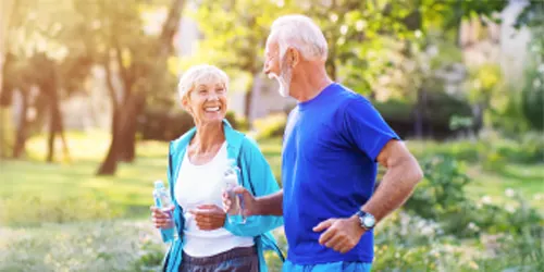 Smiling couple jogging together.
