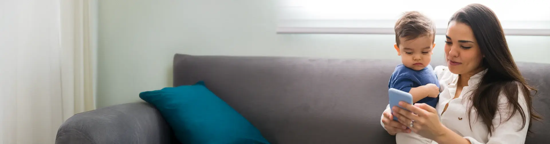 mom holding a baby and a phone